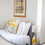 picture above a bed with cushions on 