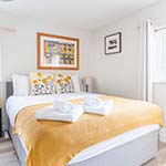 bed with yellow blanket on