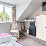 kitchen area in a room next to a window 