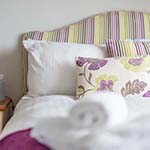 flower cushions and stripped headboard