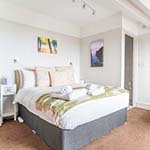 bed with prints o the wall