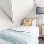 single bed with tv above it 