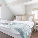 bed decorated with a blue blanket