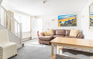 living area with staicase and art on the wall